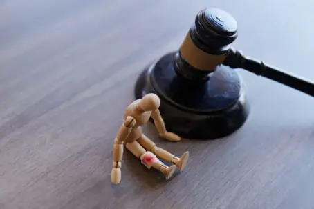 a gavel and a mini mannequin with a fake injury.