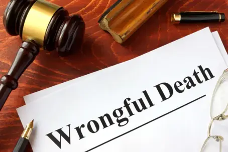 a gavel and a paper that says wrongful death.