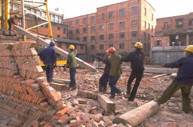 A red-brick building is shown, likely an office or apartment complex.